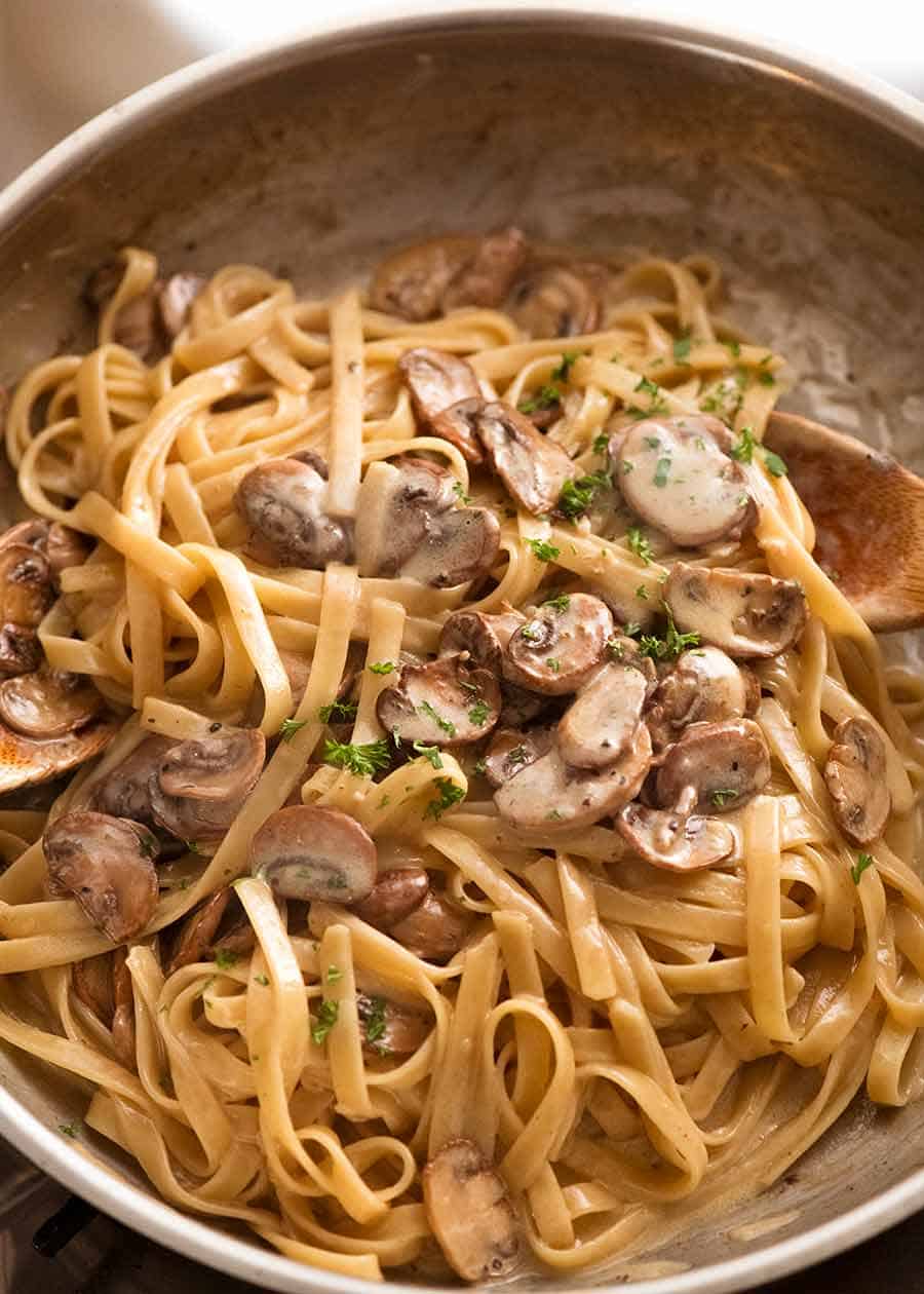 Mushroom pasta with Alfredo sauce in a pan, fresh off the stove